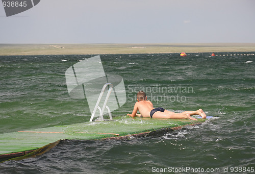 Image of Boy laying down on pier