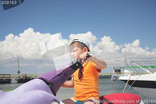 Image of Boy driving water scooter 