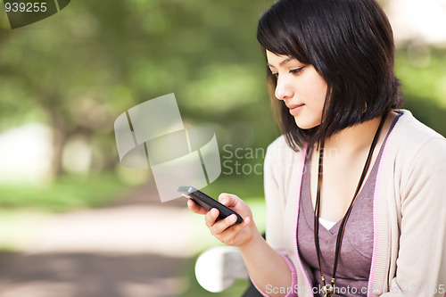 Image of Mixed race student texting