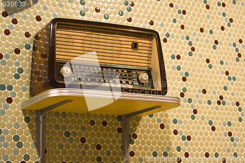 Image of vintage radio on yellow background 