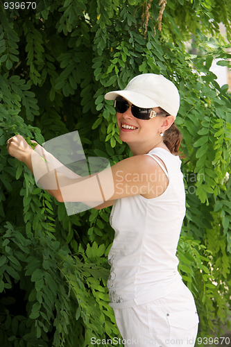 Image of Smiling woman at tree