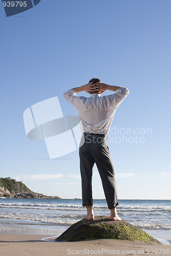 Image of Businessman relaxing on a beach