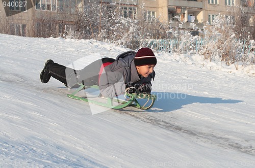 Image of happy asian boy on sledge