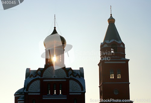 Image of ray of sunset lighting trough church silhouette