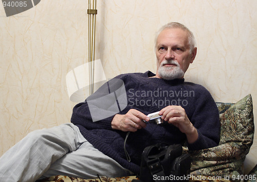 Image of thoughtful senior with camera