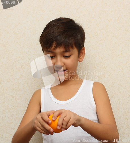 Image of boy, peeling the orange