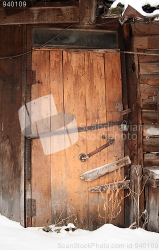 Image of closed wooden  door of old shed