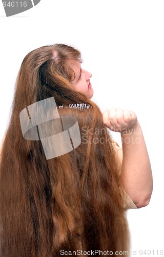 Image of women combing her beautiful long red hair