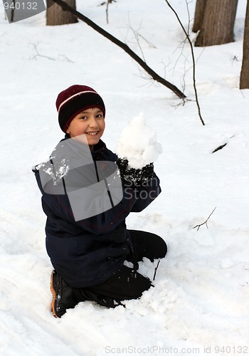 Image of happy boy with snowball