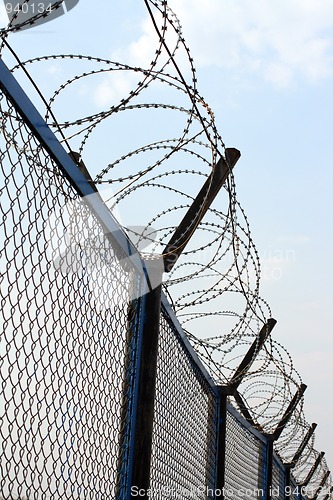 Image of fence with barbed wire