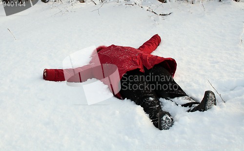 Image of woman, lying on snow