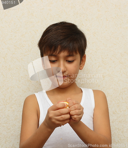 Image of boy, peeling the orange