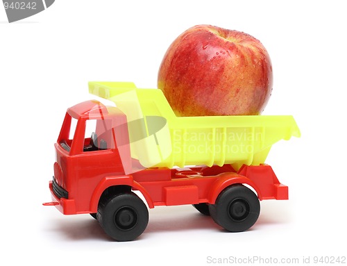 Image of food transportation concept - toy lorry with apple
