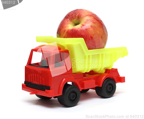 Image of food transportation concept - toy lorry with apple