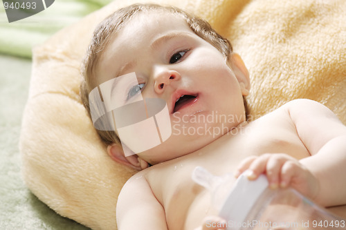Image of Serene baby with bottle closeup