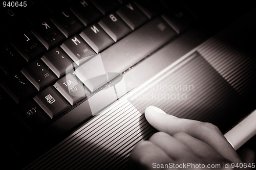 Image of Working at laptop .