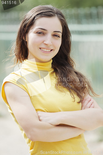 Image of Young woman arms folded