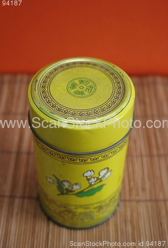 Image of Old Chinese tea tin on bamboo - copy space