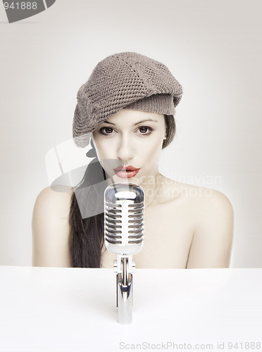 Image of Sexy woman singing in retro mic