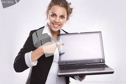 Image of pretty businesswoman holding laptop