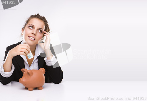 Image of Savings - Business woman at work holding English  pound currency