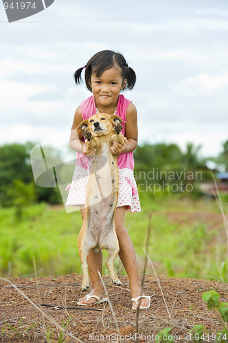 Image of farmer girl holding a dog