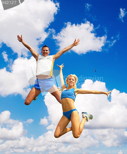 Image of The sportsmans in a jump against the sky