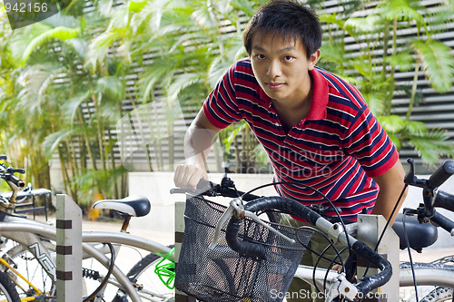 Image of asia man take bike in bicyle park