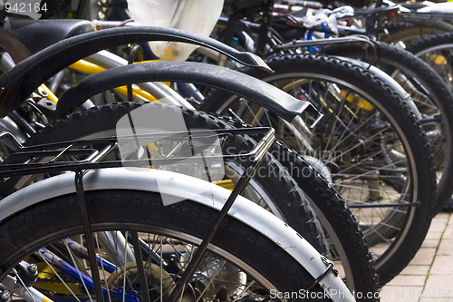 Image of some urban rentable bike in parking 