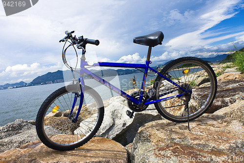 Image of bike in the sea bay and blue sky