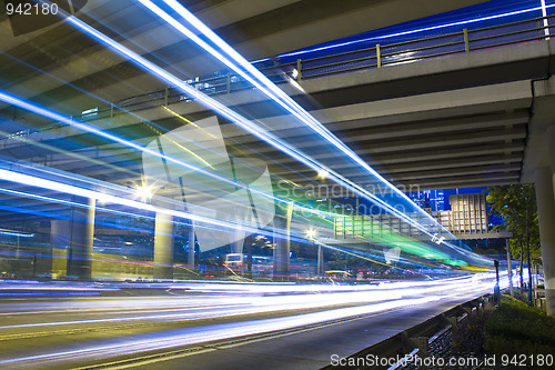 Image of Freeway in night with cars light in modern city. 