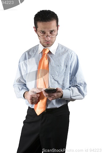 Image of Businessman looking over his glasses with PDA on hand