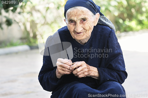 Image of Smiling elderly woman with cherry