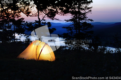 Image of A tent lit up at dusk 