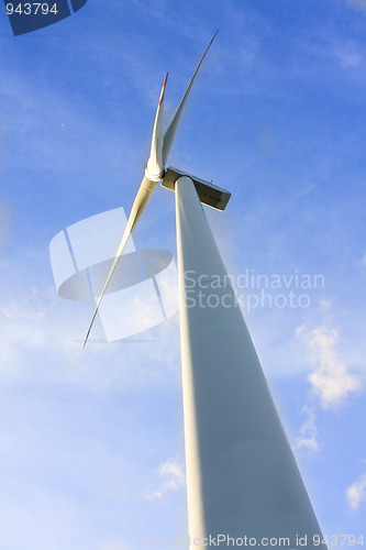 Image of wind turbine generating electricity on blue sky 