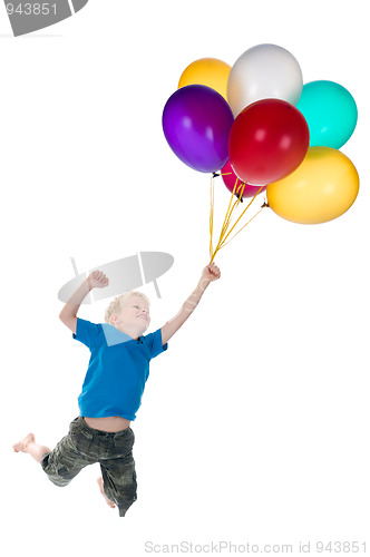 Image of Boy Flying Behind Balloons