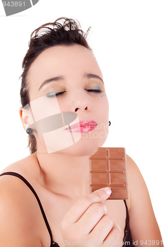Image of beautiful young woman tasting chocolate