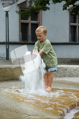 Image of Boy Playing With Fountain