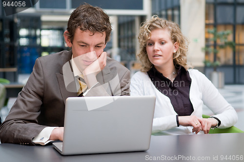 Image of Curious Businesswoman Looking At Her Colleague