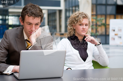 Image of Curious Businesswoman Looking At Her Colleague