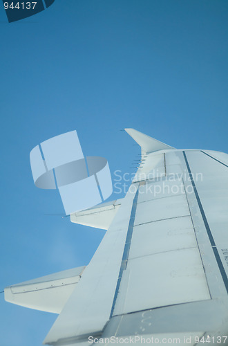 Image of Wing of airplane against a blue sky