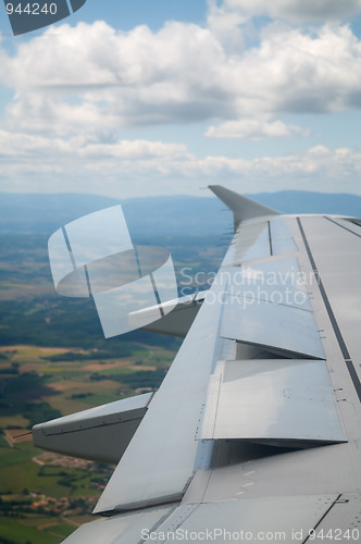 Image of Wing of airplane going to land