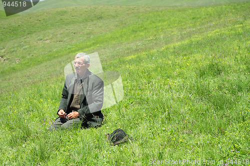 Image of Man telling beads