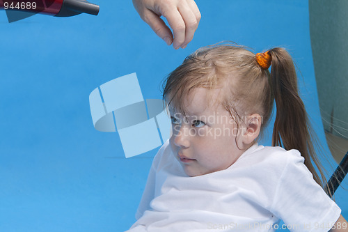 Image of Cute small girl is preparing for photosession