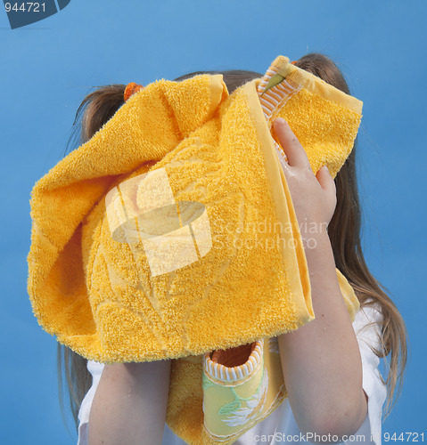 Image of Small girl is wiping its face by towel isolated