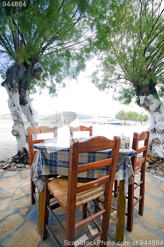 Image of typical Greek taverna chairs table seaside Antiparos Island