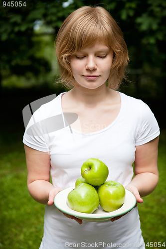 Image of Girl holding fresh green apples