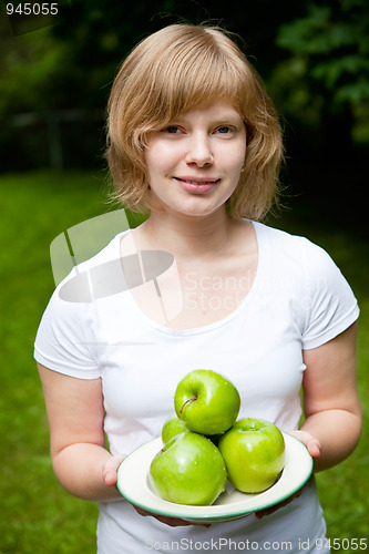 Image of Girl holding fresh green apples