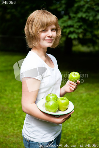 Image of Girl holding fresh green apples