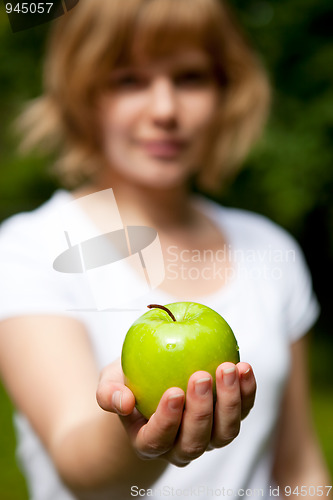 Image of Girl holding a fresh green apple